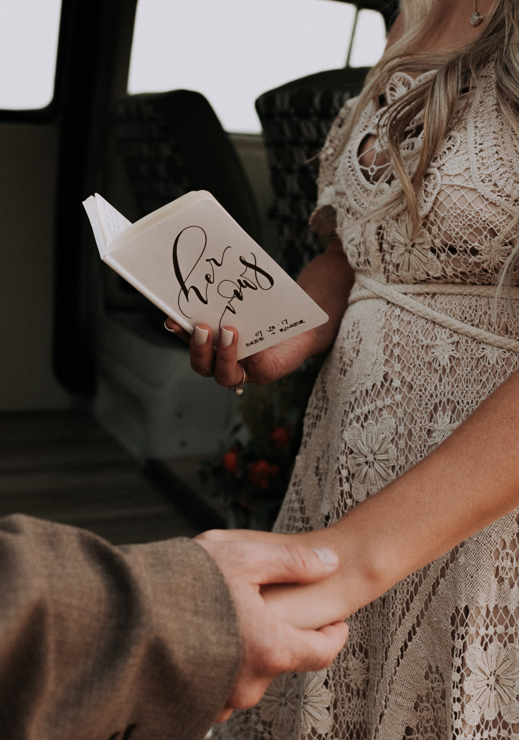 woman holding her vow book for elopement ceremony in canyons, elopement photography