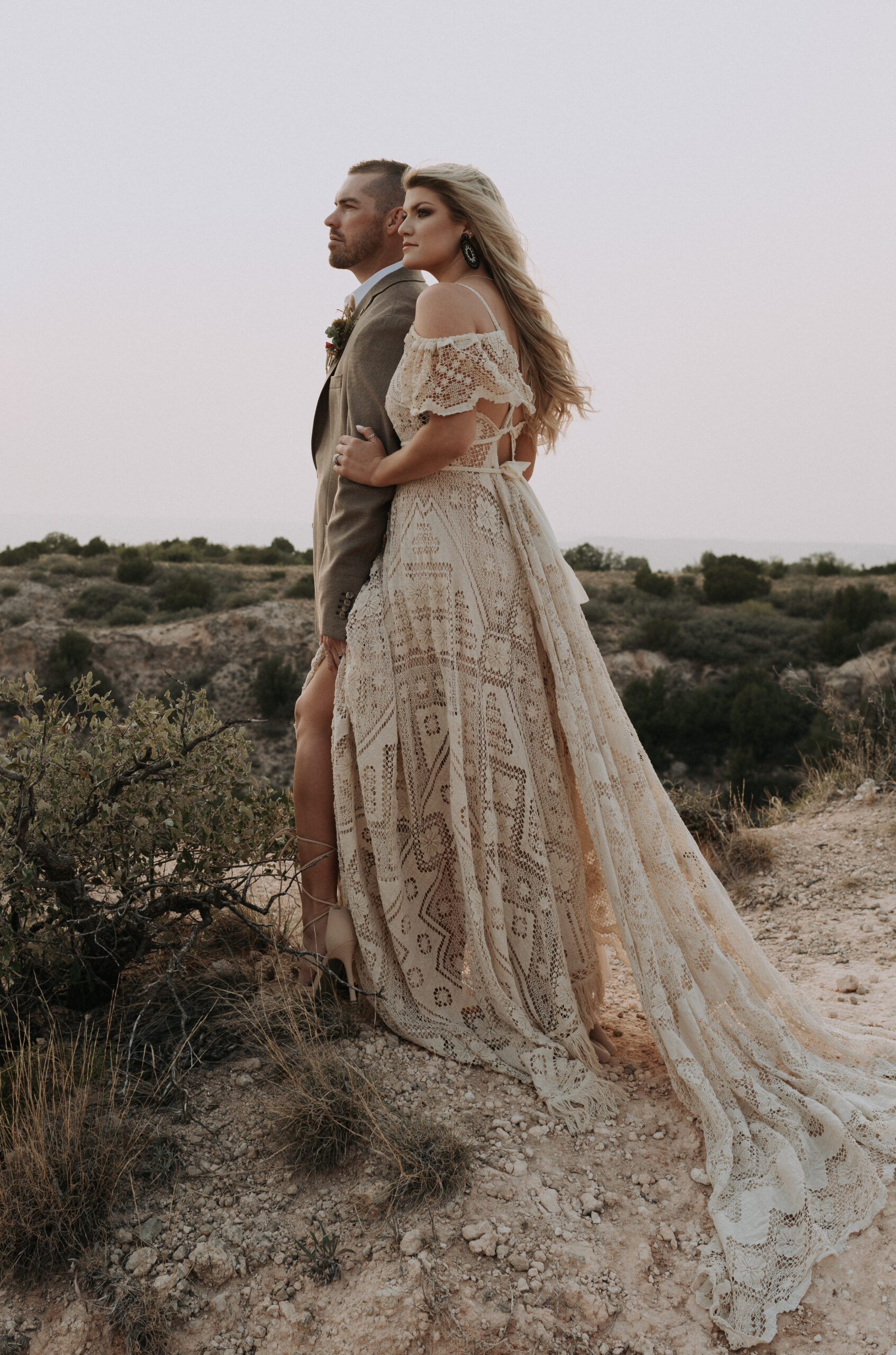 woman holding mans arms whiling looking out to the left side for their adventure elopement photoshoot