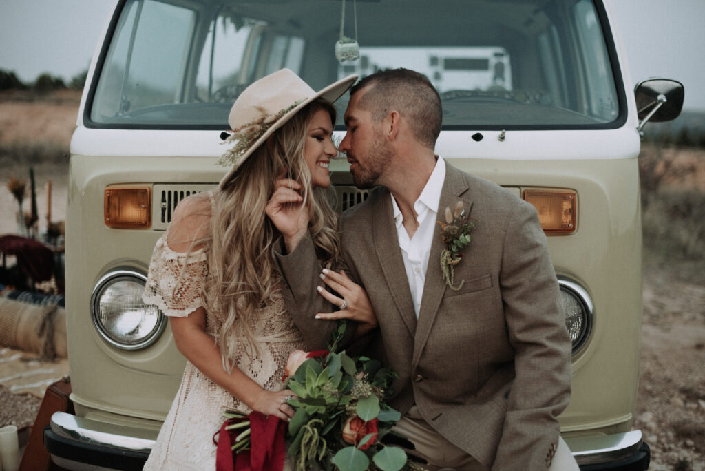 man touching womans hair while looking at her in front of car during elopement