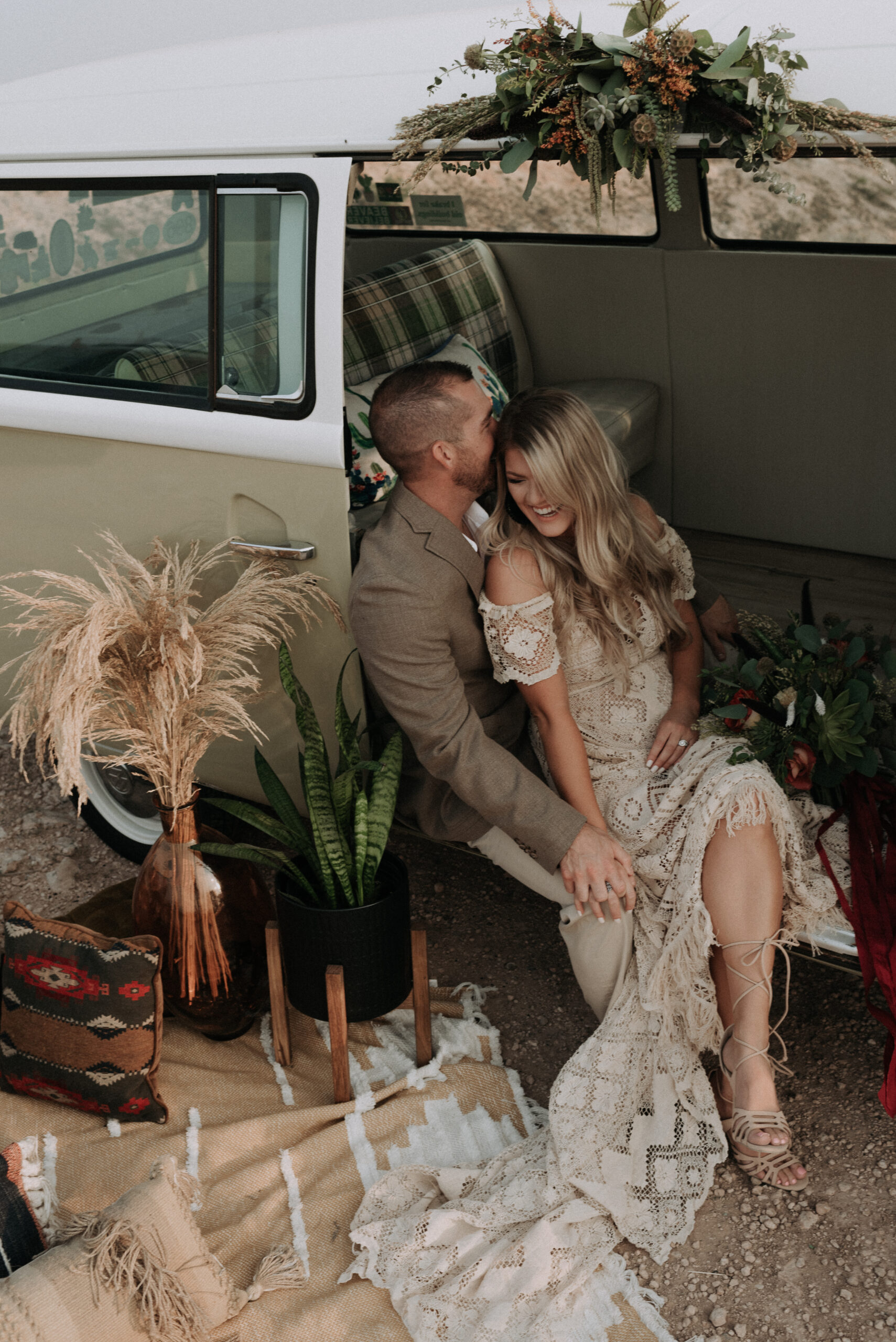 man and woman sitting together in a van while laughing during their elopement ceremony in the canyons. Adventure destination elopement photoshoot and photographer