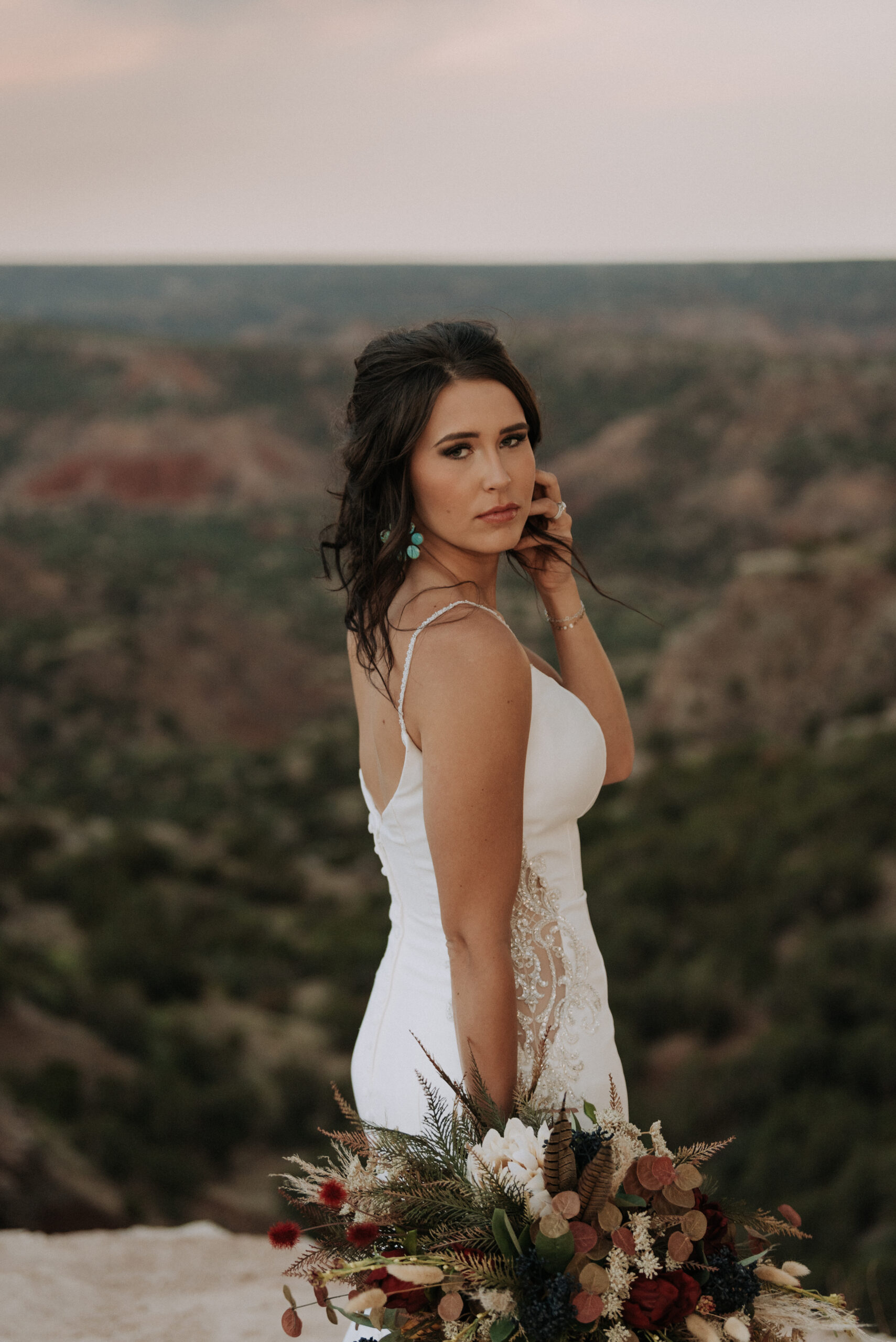 woman holding hair while looking at camera while posing for wedding bridal photos, bridal portraits, texas elopement photographer
