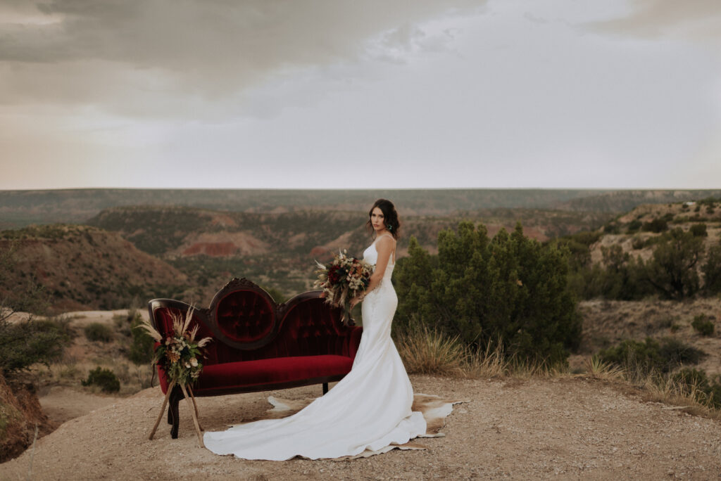 bride holding bouquet while posing for bridal photos in front of settee - texas wedding photographer